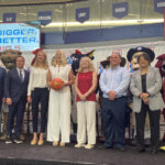 Coaches and officials pose for a photo following Thursday's press conference announcing changes to the Big 5.